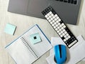 Workplace with laptop, blue wireless mouse, envelopes, notebook, office desk, Royalty Free Stock Photo