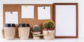 Workplace Mockup. Scandinavian style banner. Three white stickers, empty vertical frame, two cups of coffee, two cactus on a white