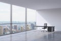 A workplace in a modern corner panoramic office in New York, Manhattan. A black leather chair and a black table. Royalty Free Stock Photo