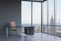 A workplace in a modern corner panoramic office in New York, Manhattan. A brown leather chair and a black table.