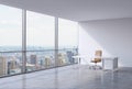 A workplace in a modern corner panoramic office in New York, Manhattan. A brown leather chair and a white table.