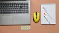 Workplace of a modern doctor. Laptop, wireless mouse, notebook, pills, syringe on a blue pastel background. Top view, minimalist t