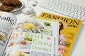 Workplace with modern magazines on white table, closeup Royalty Free Stock Photo