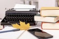 Workplace of modern writer with old typewriter, books, notebook and pen, telephone. Autumn mood. Royalty Free Stock Photo