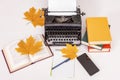 Workplace of modern writer with old typewriter, books, notebook and pen, telephone. View from above. Autumn mood. Royalty Free Stock Photo