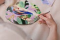 Workplace of the mosaic master: women`s hands holding tool for mosaic details in the process of making a mosaic Royalty Free Stock Photo