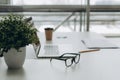 Workplace with notebook laptop Comfortable work table in office windows and city view