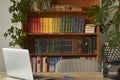 Workplace with notebook laptop in the home library, quarantined work from home, remote work Royalty Free Stock Photo