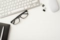 Workplace of office clerk. Frame border flatlay view photo of computer keyboard with paper clips leather diary eyewear isolated