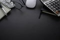 Workplace office with dark grey desk. Close-up view from above of keyboard, glasses with notebook and mouse. Tabletop space for cr Royalty Free Stock Photo