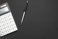 Workplace office with dark grey desk. Top view from above of Empty open notebook with calculator and pens with paper clip. Flat Royalty Free Stock Photo