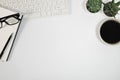 Workplace in office with white desk. Top view from above of keyboard with notebook and coffee. Space for modern creative work of d Royalty Free Stock Photo