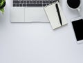 Workplace in office with white desk. Top view from above of keyboard with notebook and coffee. Space for modern creative work of d Royalty Free Stock Photo