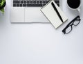 Workplace in office with white desk. Top view from above of laptop with notepad and coffee. Space for modern creative work of desi Royalty Free Stock Photo