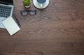 Workplace in office with wood table. Top view from above of laptop with notepad and coffee. Space for modern creative work of desi Royalty Free Stock Photo