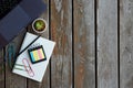 Workplace in office with wooden table. A flatlay with a laptop, notepad, different stationery and a plant.