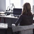 Workplace with open laptop with black screen on modern wooden desk