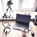 Workplace with open laptop with black screen on modern wooden desk Royalty Free Stock Photo