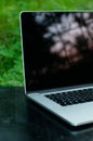 Workplace outdoors. Freelancer workplace. Laptop on dark wooden table