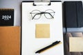 Workplace with paper holder, notepads, sticky notes, pens, glasses and calendar Royalty Free Stock Photo