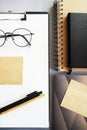 Workplace with paper holder, notepads, sticky notes, pens, glasses and calendar Royalty Free Stock Photo