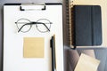 Workplace with paper holder, notepads, sticky notes, pens, glasses and calendar Royalty Free Stock Photo