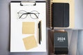 Workplace with paper holder, notepads, sticky notes, pens, glasses and calendar Royalty Free Stock Photo