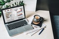 Workplace without people, close-up of laptop with graphs, charts, diagrams on screen on white table, desk. Royalty Free Stock Photo