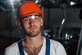 At workplace. Portrait of engineer in metallurgical factory in protective helmet and eyewear