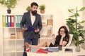 Workplace relations. Business professionals at workplace. Working couple solve workplace problem. Bearded man and sexy