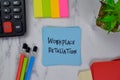 Workplace Retaliation write on sticky notes isolated on Wooden Table