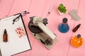 Workplace scientist doctor - microscope, pills, syringe, eyeglasses, chemical flasks with liquid, clipboard on pink wooden table Royalty Free Stock Photo