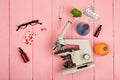 Workplace scientist doctor - microscope, pills, syringe, eyeglasses, chemical flasks with liquid on pink wooden table Royalty Free Stock Photo