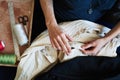 Workplace of seamstress. Dressmaker makingdetail, sew on buttons, spools of thread, tailor shop, tailoring, close up Royalty Free Stock Photo