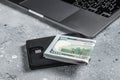 Workplace with stylish leather wallet with money, Laptop. Gray background. Top view. Copy space Royalty Free Stock Photo