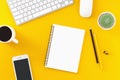 Workplace top view on a desk table over a yellow background with copyspace Royalty Free Stock Photo