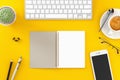 Workplace top view on a desk table over a yellow background with copyspace Royalty Free Stock Photo