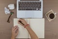 workplace top view of a hand writing in a notebook with a pen so Royalty Free Stock Photo