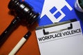 Workplace Violence text on Document form and Gavel isolated on office desk.