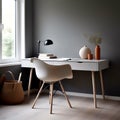 Workplace with white chair at wooden drawer writing desk against of window near dark grey wall Interior design of modern