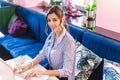 Workplace women working behind a laptop in a cafe