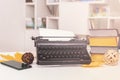 Retro and modern writer gadgets: mobile phone, old typewriter, stack of books and yellow dry leaves Royalty Free Stock Photo