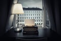 Workplace of a writer, journalist, creator. An old typewriter and a lamp on the table. Retro style. The concept on scientific,