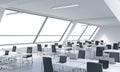 Workplaces in a bright modern open space loft office. White tables equipped by modern laptops and black chairs. White copy space i Royalty Free Stock Photo