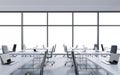 Workplaces in a modern panoramic office, copy space in the windows. Open space. White tables and black leather chairs.