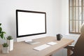 Workroom desk with computer display with isolated screen for mockup Royalty Free Stock Photo