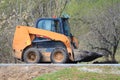 Skid steer loader goes by road