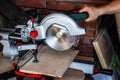 Works miter saw. The red line of the laser target pointer in the place of the future cut Royalty Free Stock Photo