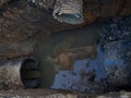 Works on the replacement of sewer pipes. Thick pipes underground. Earthworks with communications. Utility services. Sawn pipe Royalty Free Stock Photo