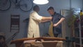 Workshop, apron, artisan and his student Royalty Free Stock Photo